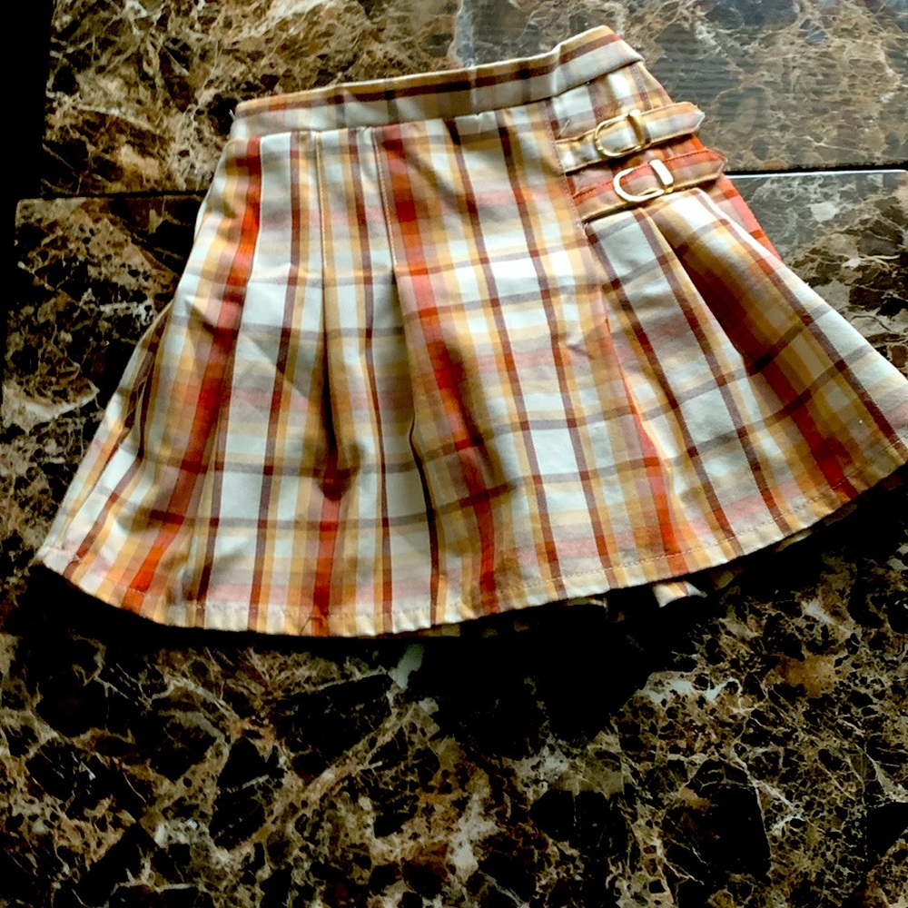 A skirt that is tan, pink and brown
